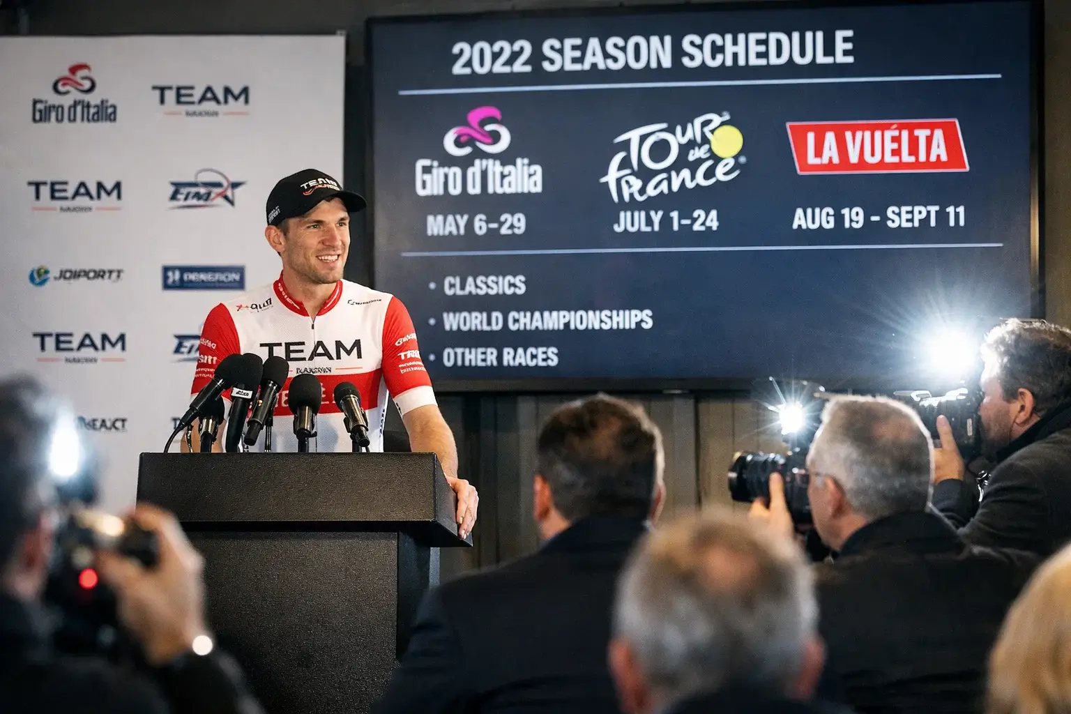 Presentazione di un team ciclistico con corridore al podio che annuncia i suoi obiettivi stagionali